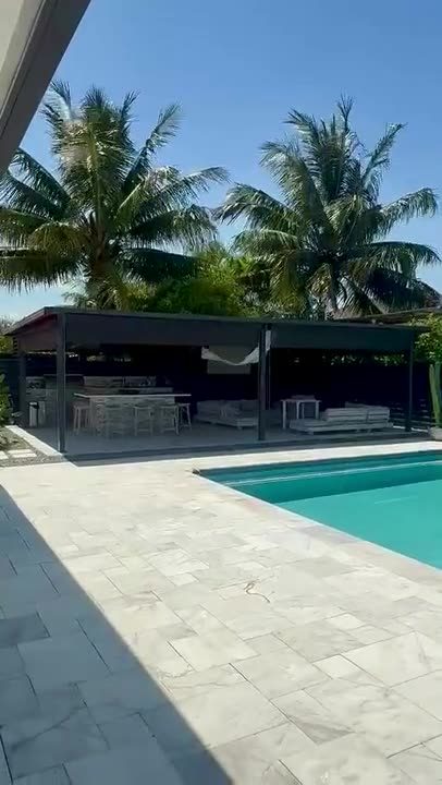 Dark screens dropping over a pool deck